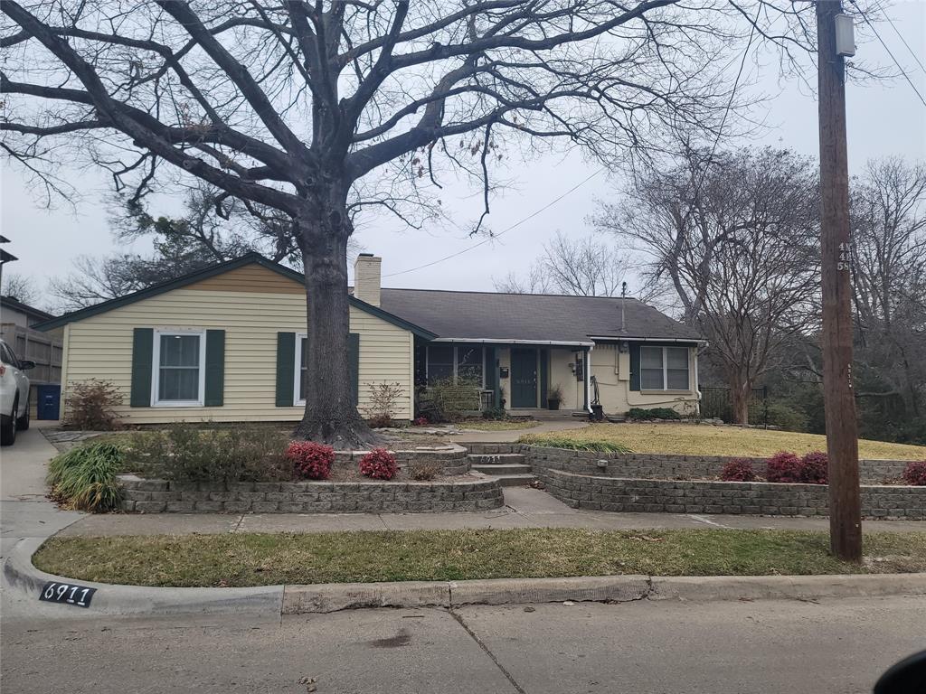 6911 Chantilly Lane Dallas, TX 75214 - Photo 1 of 5 a front view of a house with a garden