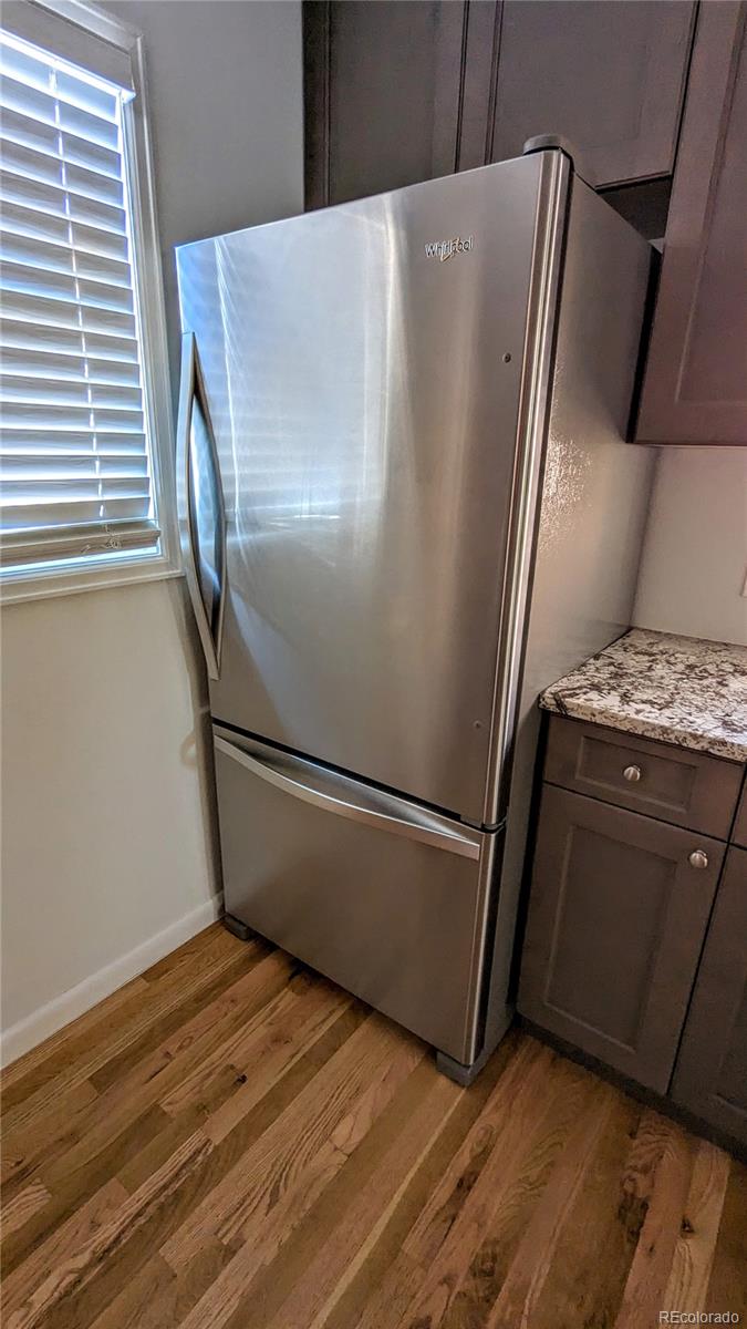 3349 Adams Street Denver, CO 80205 - Photo 11 of 31 a white refrigerator freezer sitting inside of a kitchen