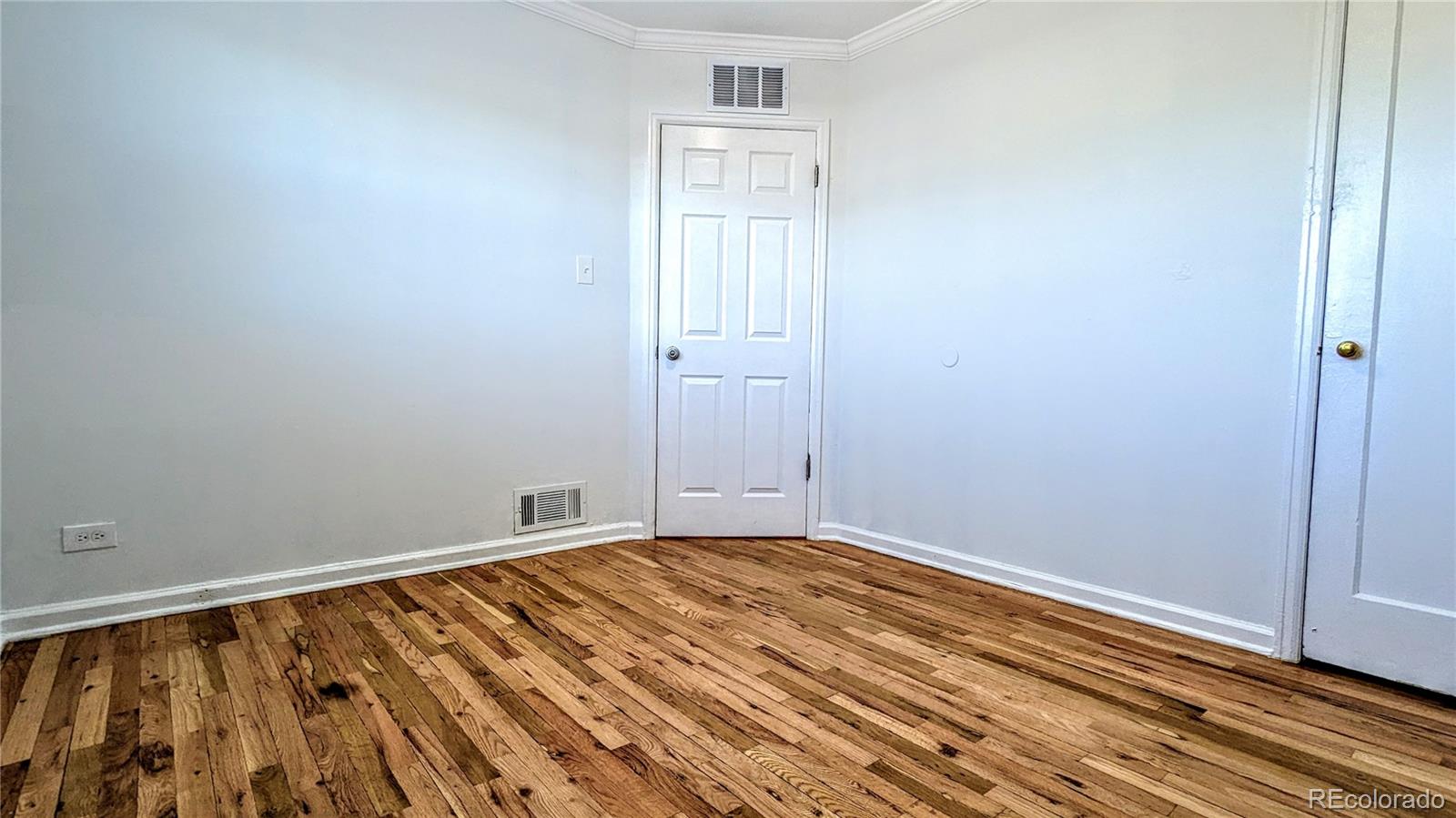 3349 Adams Street Denver, CO 80205 - Photo 14 of 31 a view of an empty room with wooden floor