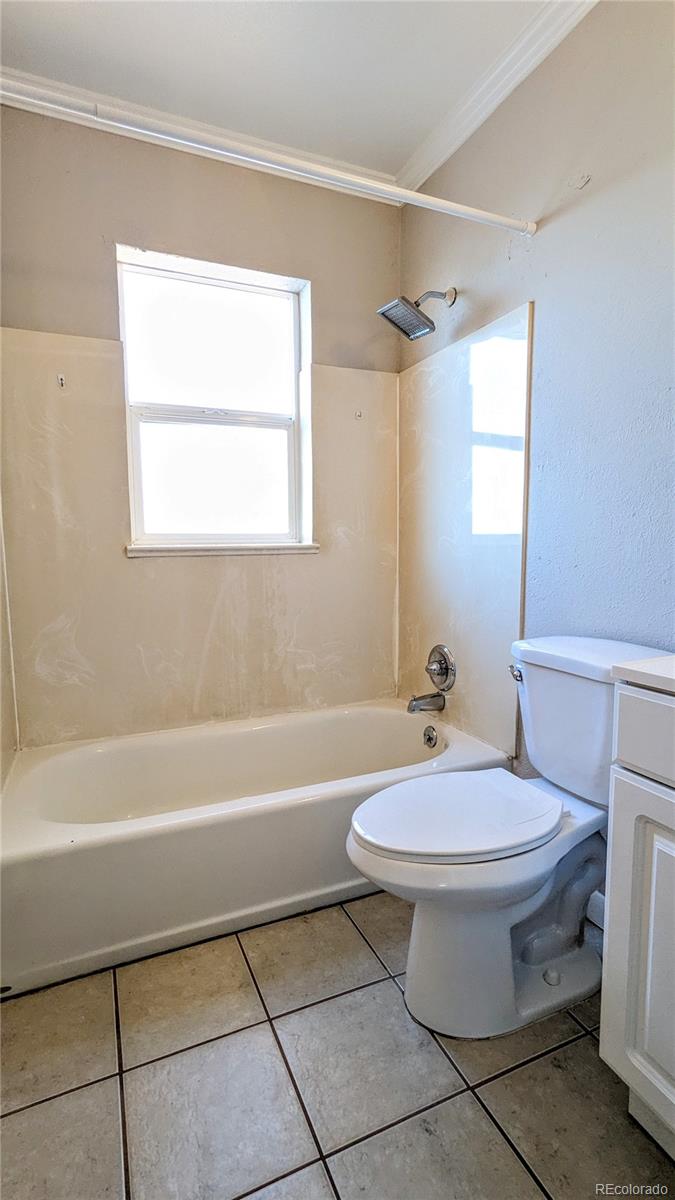 3349 Adams Street Denver, CO 80205 - Photo 16 of 31 a bathroom with a sink a toilet and bathtub