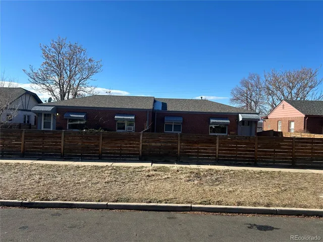 a view of house covered with snow in front of house