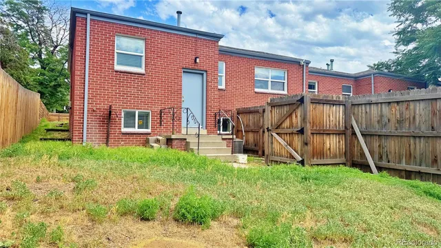 a view of a house with wooden fence