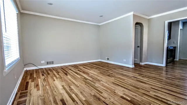 a view of a room with wooden floor and bathroom