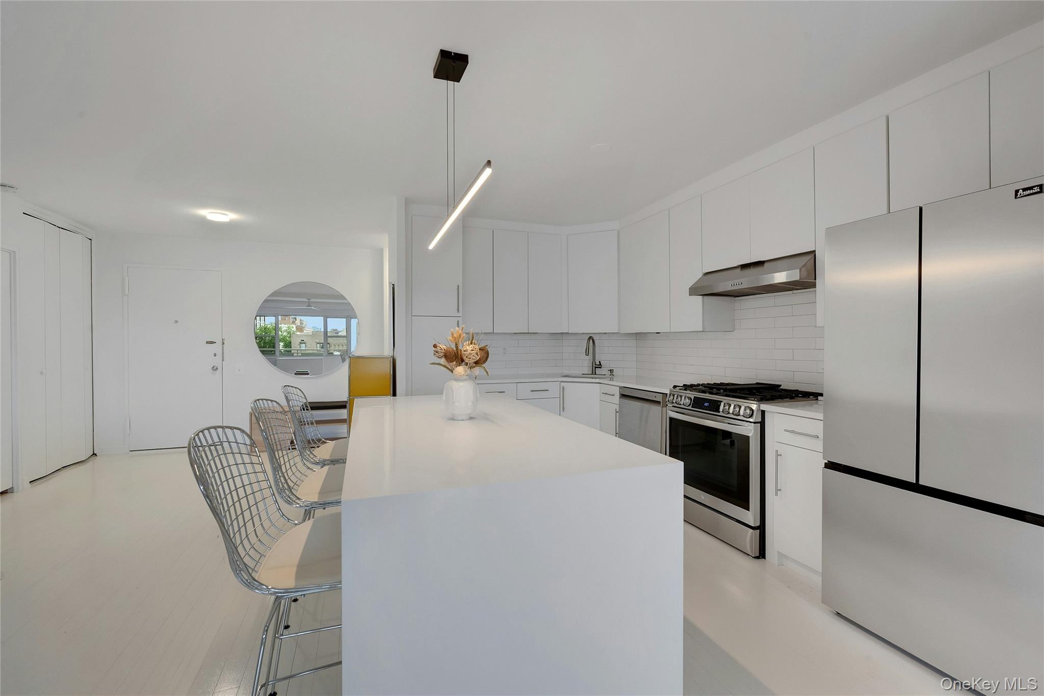 300 Martine Avenue, Unit 7B White Plains, NY 10601 - Photo 14 of 29 a kitchen with stainless steel appliances granite countertop a sink stove and refrigerator