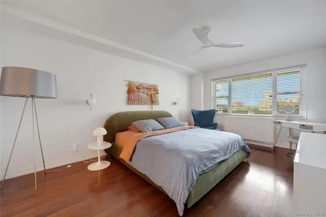 a bedroom with two beds and a large window