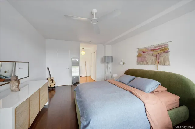 a bedroom with a bed and a large mirror