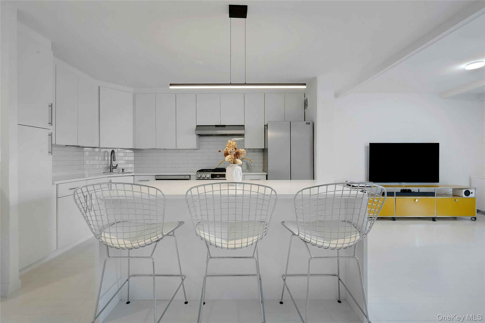 300 Martine Avenue, Unit 7B White Plains, NY 10601 - Photo 10 of 29 a living room with a couch and a flat screen tv