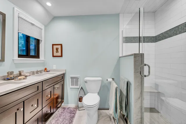a bathroom with a toilet sink and shower