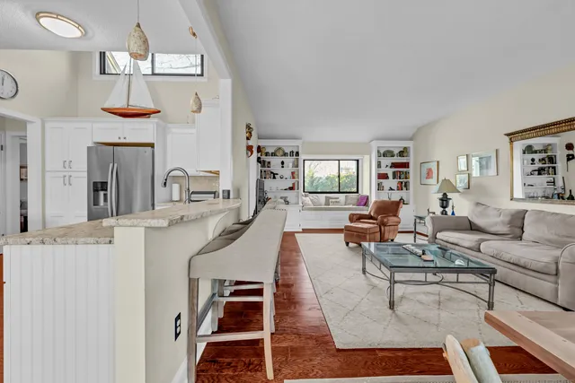 a living room with fireplace furniture and a wooden floor