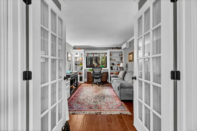 a living room with furniture and a wooden floor