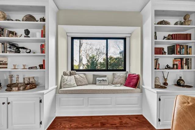 a living room with furniture and a book shelf