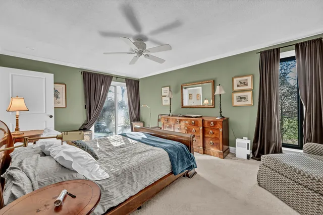 a bedroom with a large bed and a chandelier