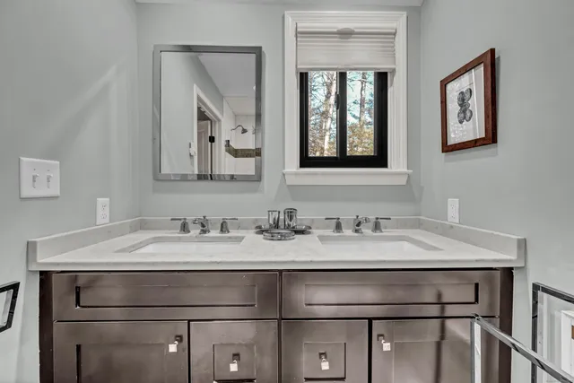 a bathroom with a granite countertop sink vanity and a mirror