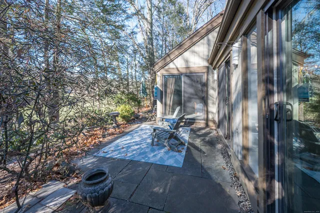 a backyard of a house with outdoor seating