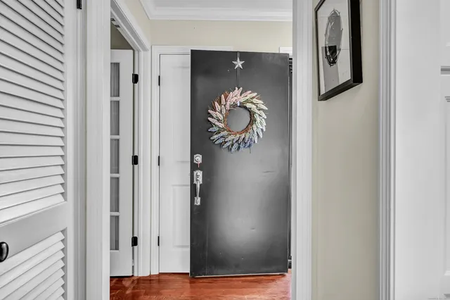 a view of a hallway with wooden floor