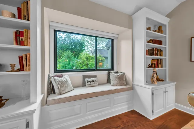 a living room with furniture and a book shelf