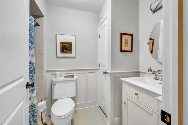 a white toilet sitting next to a bathroom sink