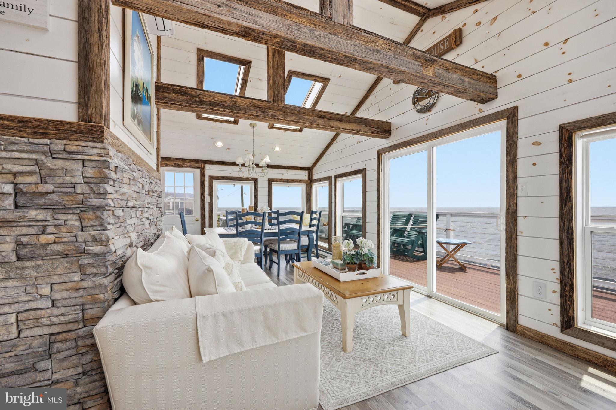 173 Cove Road Newport, NJ 08345 - Photo 3 of 72 a living room with furniture and a floor to ceiling window