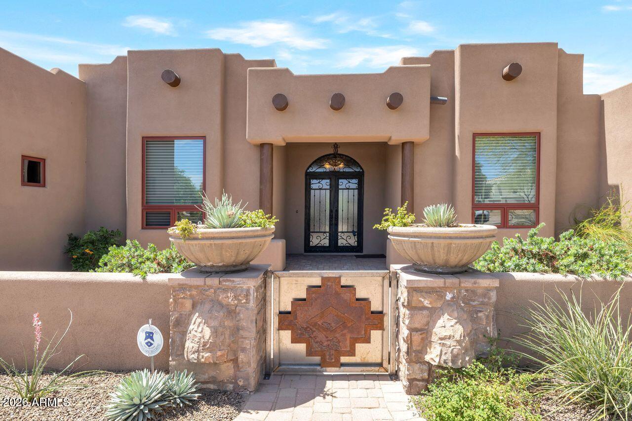 18507 East Picacho Road Rio Verde, AZ 85263 - Photo 1 of 33 a front view of a house with a garden