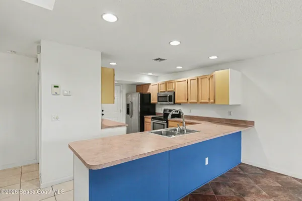 a kitchen with stainless steel appliances a sink stove and cabinets