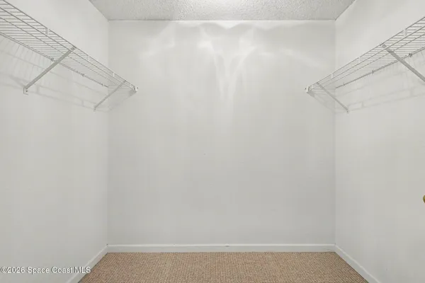 a view of washer and dryer with kitchen in the background
