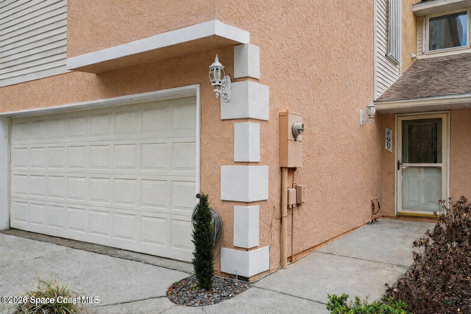 499 Arbor Ridge Lane Titusville, FL 32780 - Photo 3 of 28 a front view of a house with garage