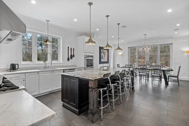 a large kitchen with lots of counter space and dining table