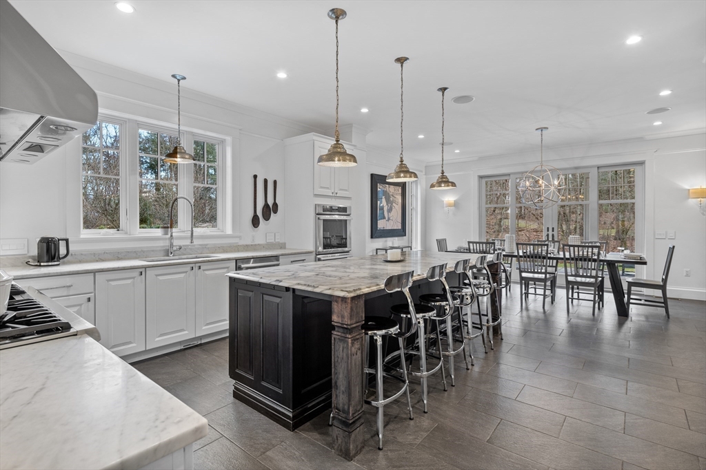 75 A Goddard Avenue Brookline, MA 02445 - Photo 5 of 27 a large kitchen with lots of counter space and dining table