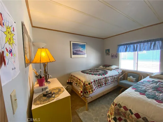 a bedroom with two beds and a window