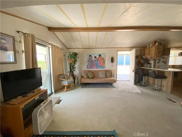 a view of game room with window and flat screen tv