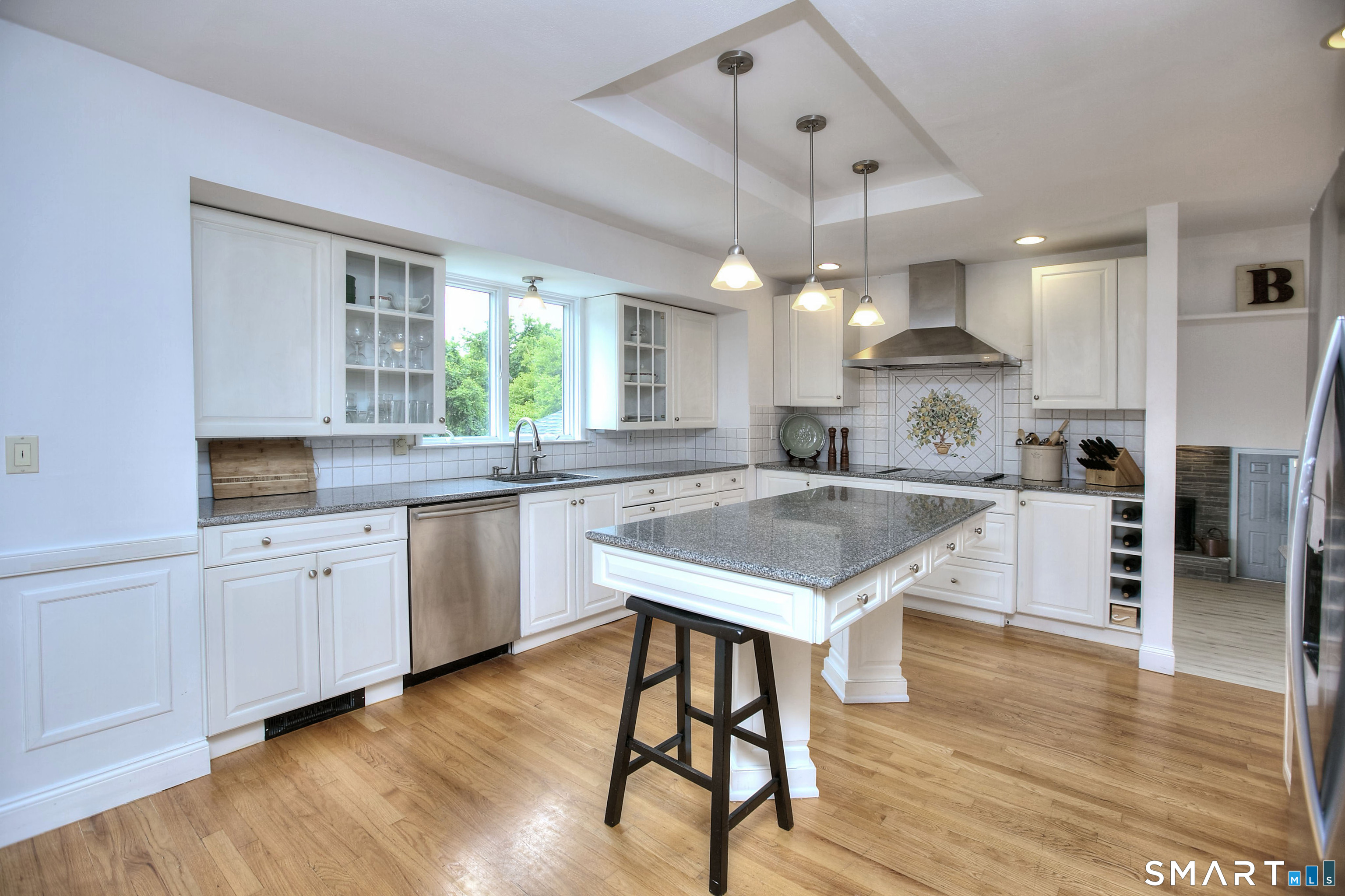 324 Ridge Road Orange, CT 06477 - Photo 13 of 38 a kitchen with a table chairs sink and cabinets