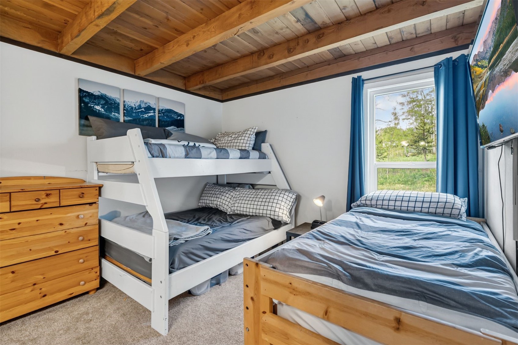 8100 Ryan Gulch Road, Unit 106 Wildernest, CO 80498 - Photo 17 of 43 a bed sitting in a bedroom next to a window