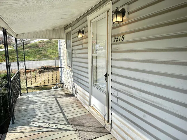 a view of a balcony with a floor to ceiling window with wooden floor
