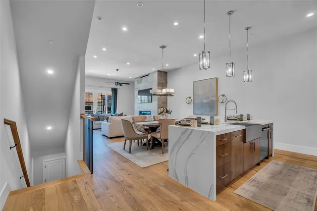 a large kitchen with kitchen island a sink a stove a dining table and chairs