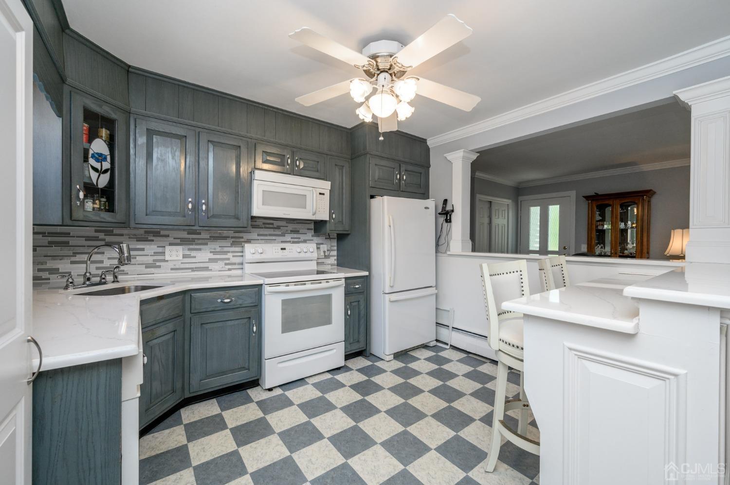 54 Manito Road Manasquan, NJ 08736 - Photo 11 of 47 a kitchen with a stove a sink and a refrigerator