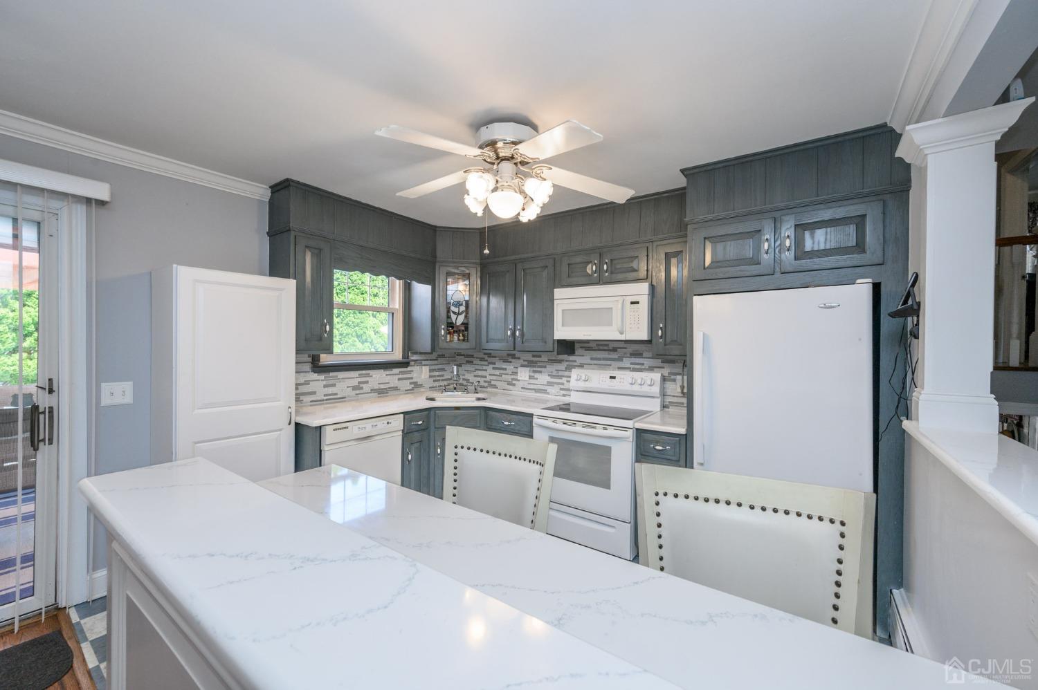 54 Manito Road Manasquan, NJ 08736 - Photo 16 of 47 a kitchen with kitchen island granite countertop a sink stove and refrigerator
