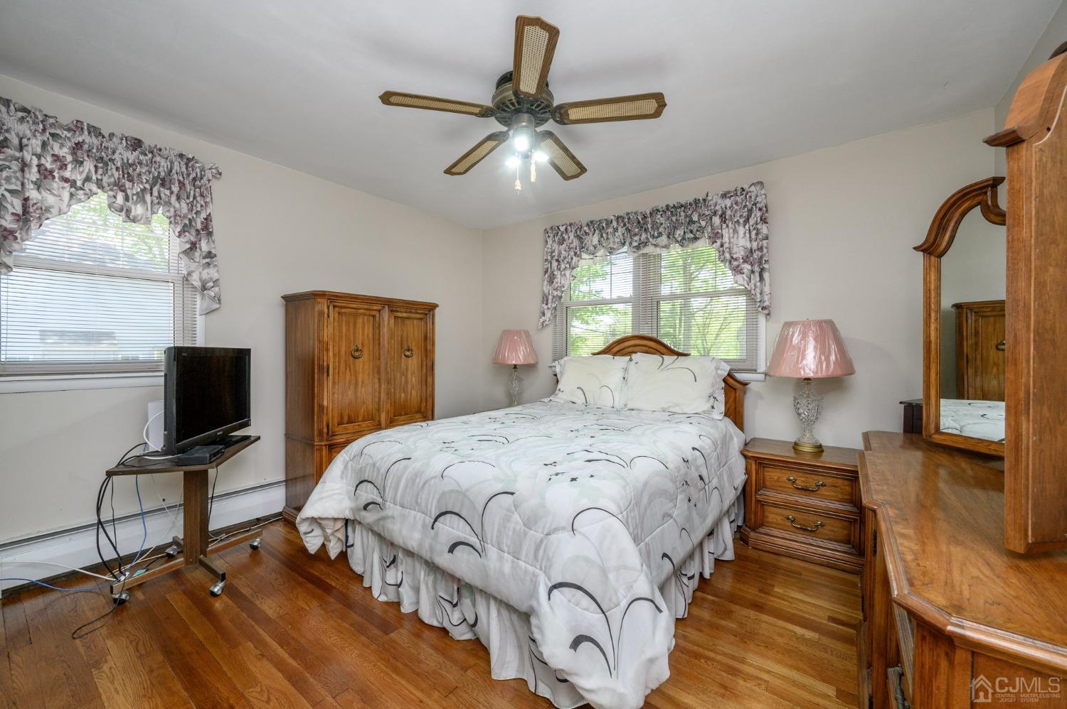 54 Manito Road Manasquan, NJ 08736 - Photo 19 of 47 a bedroom with a bed and wooden floor