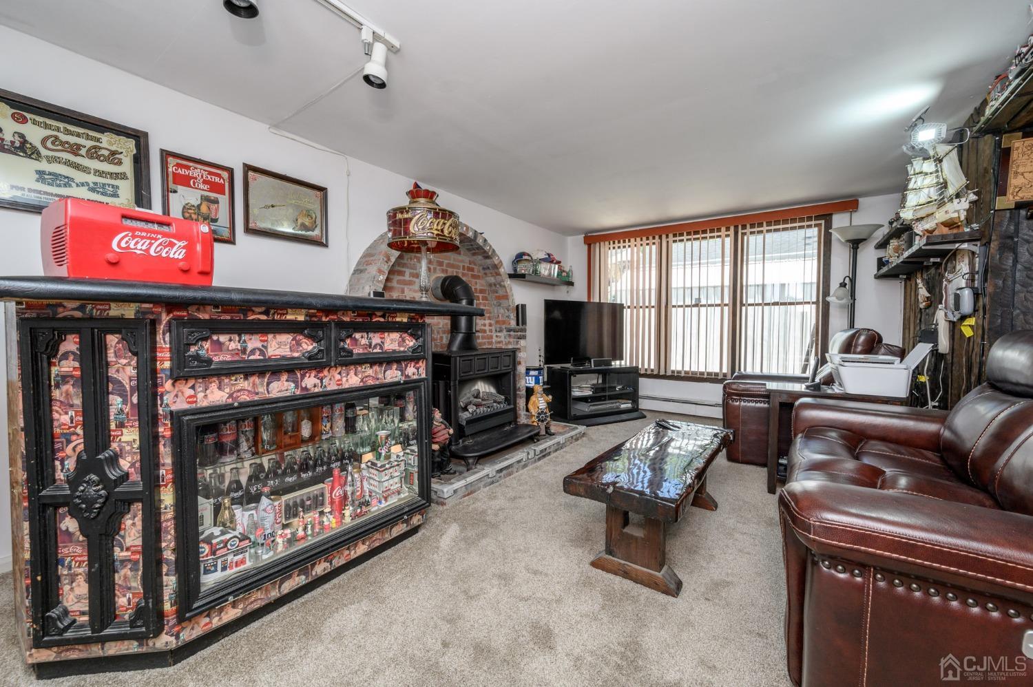 54 Manito Road Manasquan, NJ 08736 - Photo 26 of 47 a living room with furniture a window and a flat screen tv