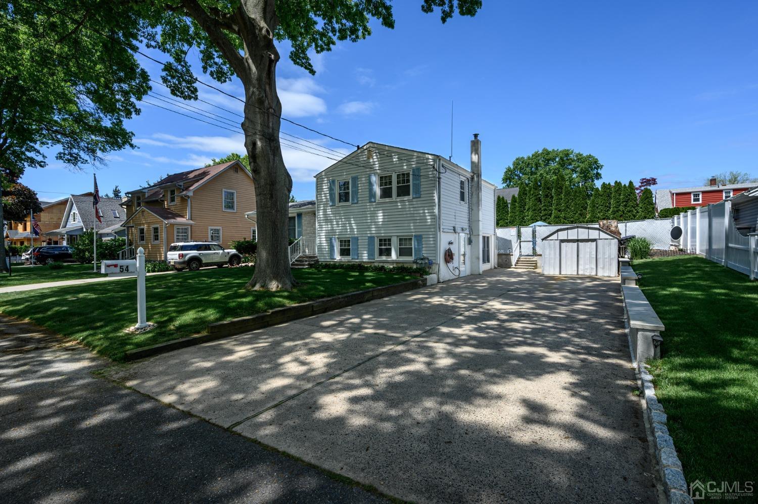 54 Manito Road Manasquan, NJ 08736 - Photo 43 of 47 a front view of a house with garden