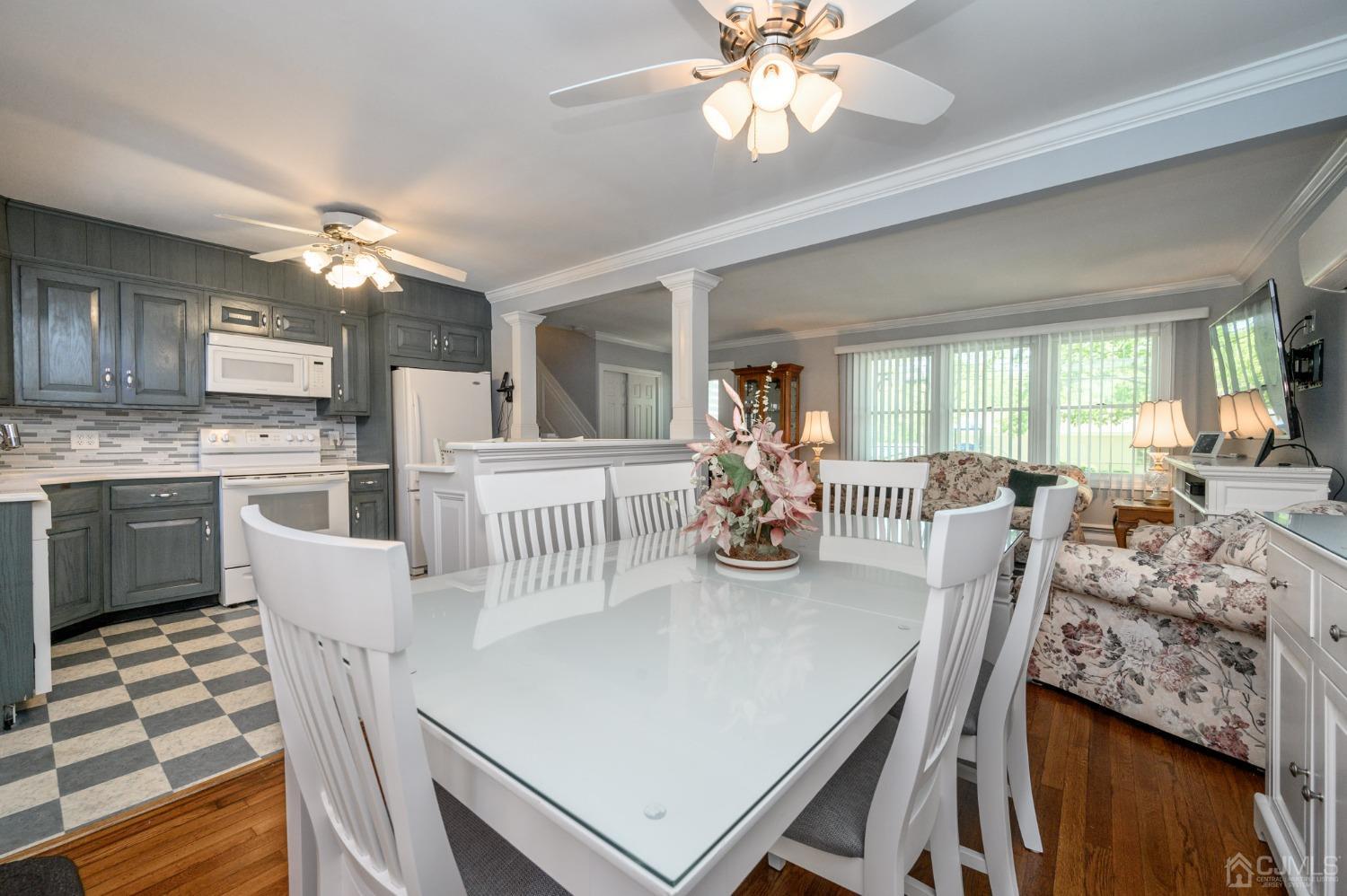 54 Manito Road Manasquan, NJ 08736 - Photo 10 of 47 a dining room with furniture a chandelier and wooden floor
