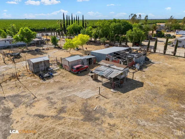 a view of a terrace with lawn chairs