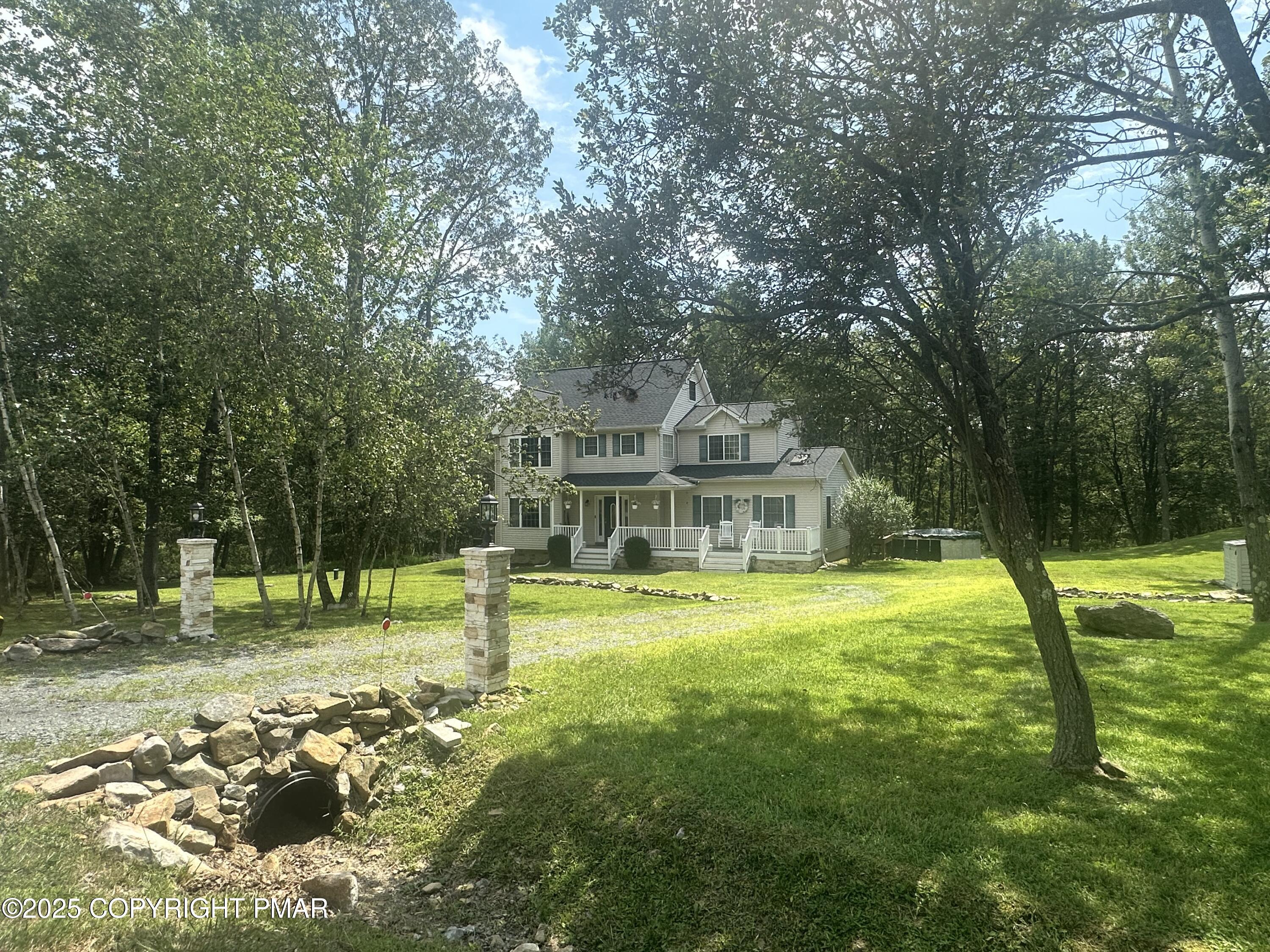 107 Horseshoe Drive Effort, PA 18330 - Photo 1 of 72 a view of a big house with a big yard and large trees