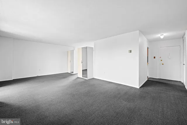 a view of an empty room and closet area