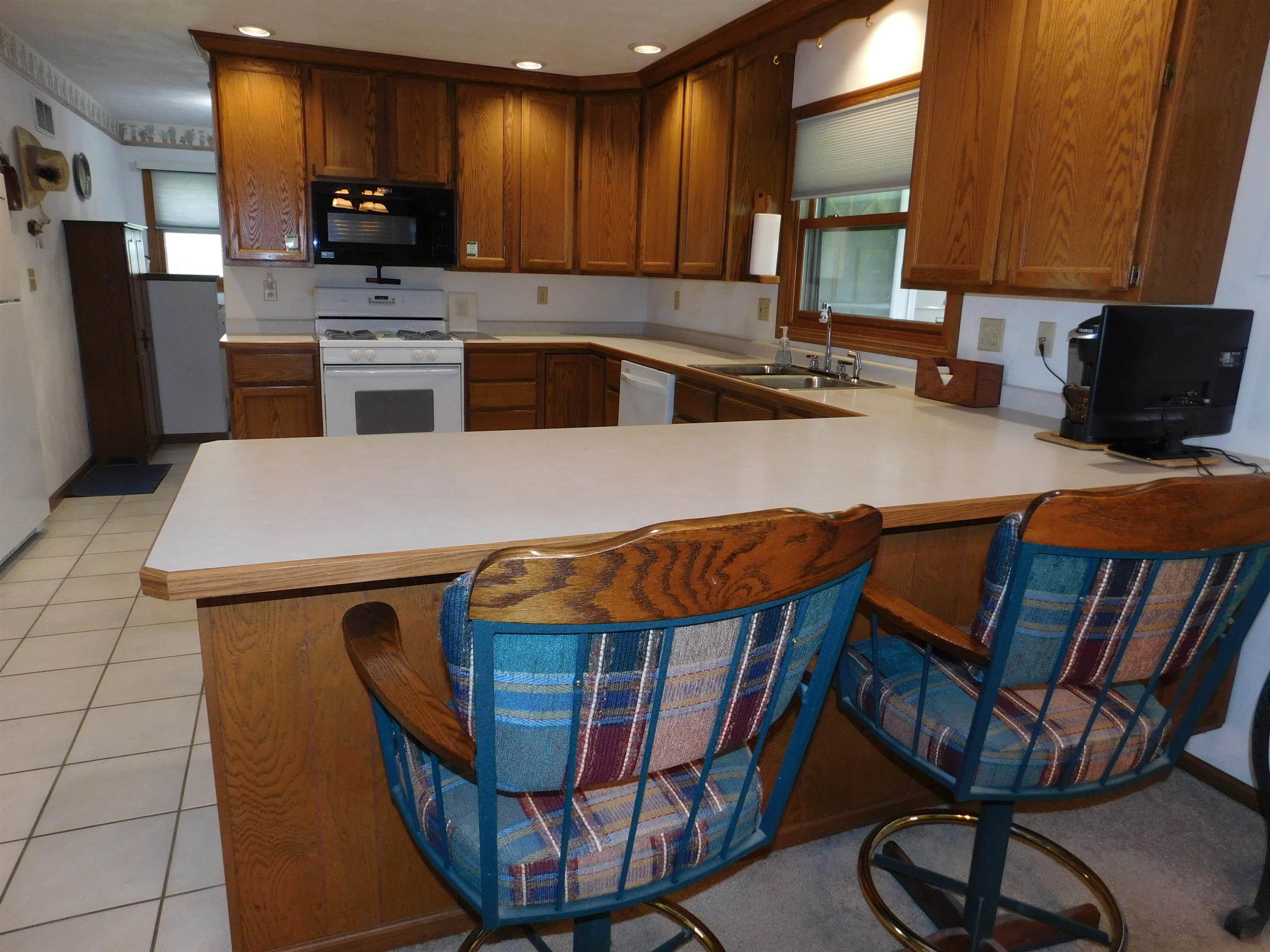 4103 North AYP Road Lena, IL 61048 - Photo 47 of 96 a kitchen with stainless steel appliances granite countertop a kitchen island a stove a sink dishwasher and cabinets
