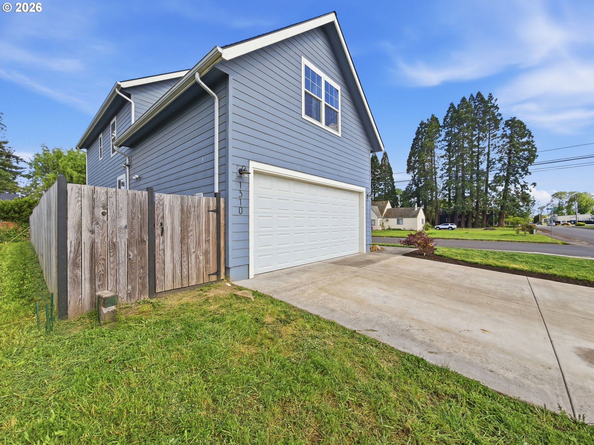 1310 Elm Street Junction City, OR 97448 - Photo 3 of 39 a front view of a house with garden