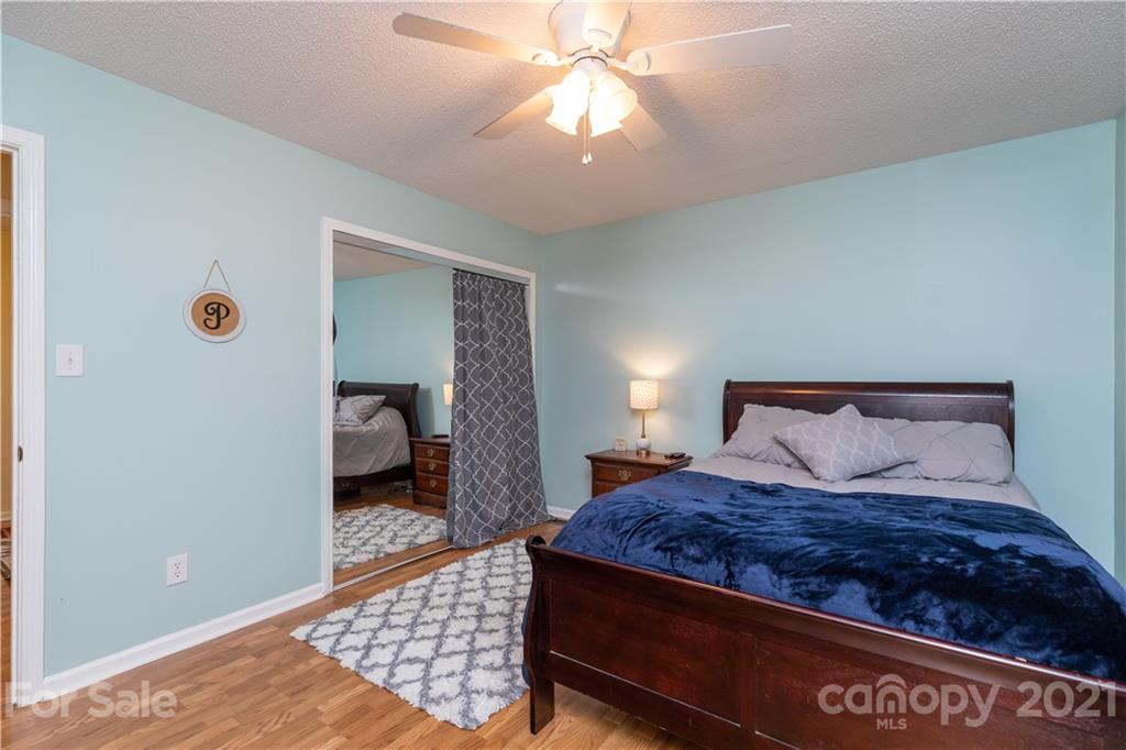 762 State Rd S-46-1086 Clover, SC 29710 - Photo 15 of 34 a bedroom with a large bed and a chandelier