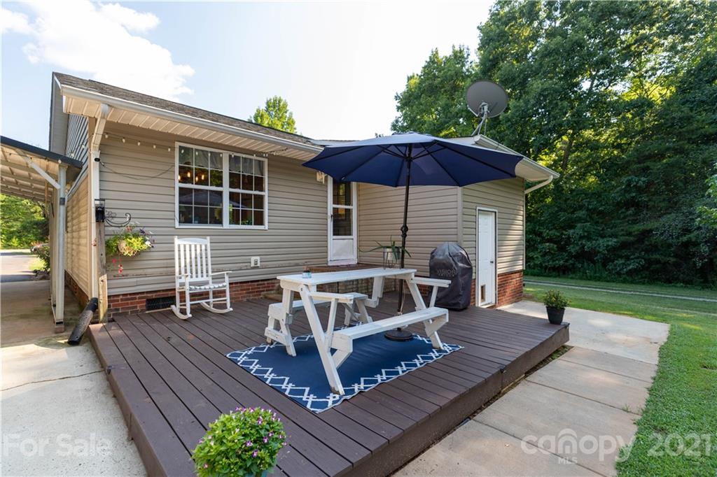 762 State Rd S-46-1086 Clover, SC 29710 - Photo 20 of 34 a view of a patio with table and chairs under an umbrella