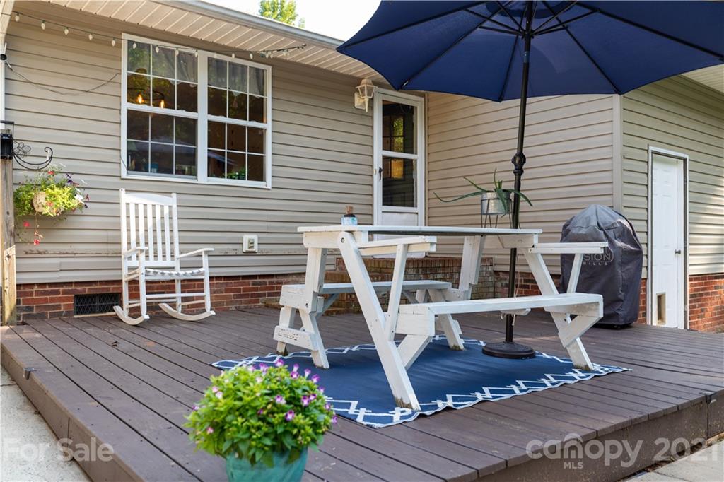 762 State Rd S-46-1086 Clover, SC 29710 - Photo 22 of 34 a view of a deck with table and chairs under an umbrella