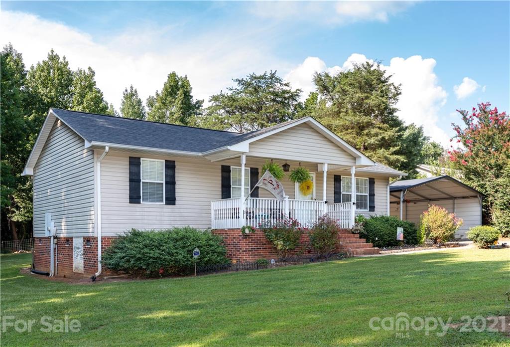 762 State Rd S-46-1086 Clover, SC 29710 - Photo 30 of 34 a front view of a house with a garden and porch