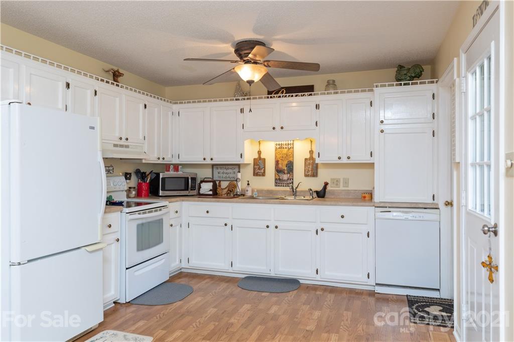 762 State Rd S-46-1086 Clover, SC 29710 - Photo 7 of 34 a kitchen with granite countertop white cabinets white appliances and sink